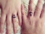 Matching anchors ring finger tattoos are nice for those who love the sea and are having a coastal wedding