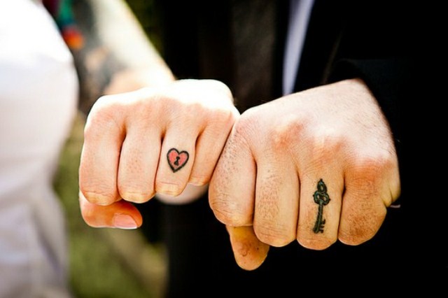 Colorful heart and key tattoos for the bride and groom