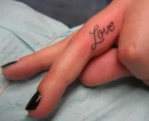 a delicate love wedding tattoo placed on your ring finger is a stylish idea for a wedding or just if you want a meaningful tattoo