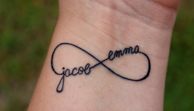 an infinity sign tattoo with the names placed on the wrist is a fresh take on a usual infinity sign tattoo