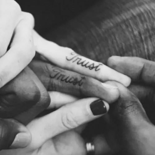 'Trust' tattoos placed on your ring fingers are a perfect solution to highlight what's important in the relationship for you