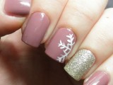 mauve nails with a half snowflake and a gold glitter nail as an accent look fun and cool