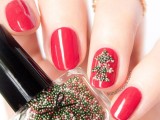 bold red nails with an accent nail that shows off a green bead tree are very creative, bold and stylish for a color-loving bride