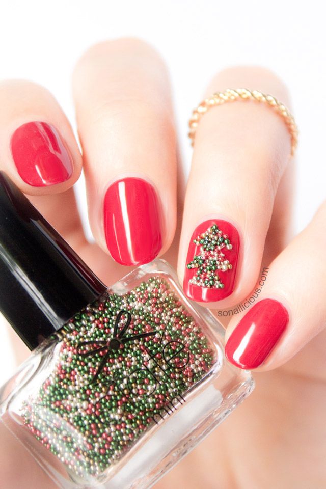 bold red nails with an accent nail that shows off a green bead tree are very creative, bold and stylish for a color loving bride