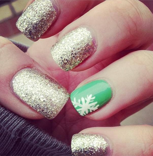 a gold glitter manicure and a bold green accent nail with a snowflake for a modern color loving bride