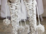 white fur knee boots with lace and fur pompoms are great for a cold or snowy wedding and can be worn at a mountain wedding, too
