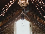 string lights paired with elegant chandeliers are amazing to light up a wedding venue, whether it’s a barn or not