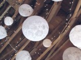 string lights paired with doily sphere pendant lamps are amazing for a wedding venue, whether it’s a barn or not