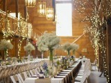 string lights covering the trees and branches in the venue making them look blooming, and elegant pendant lamps imitating candles add chic to the space
