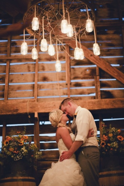 a rustic chandelier of vine and glass jars is a creative way to light up your wedding venue, and it can give your space a cozy rustic feel