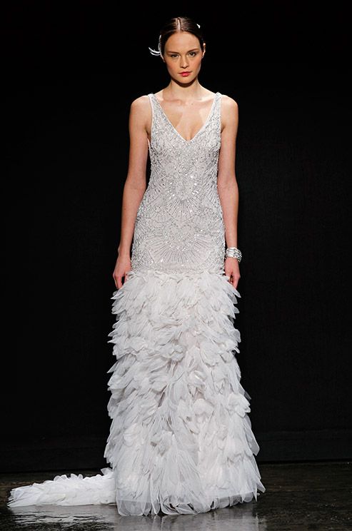 a chic 20s inspired wedding dress with a fully beaded bodice and a ruffle skirt, with no sleeves and a V neckline