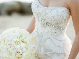 a strapless fully embellished wedding dress with a ruffle skirt is a chic and refined solution for a sophisticated bride