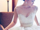 a sleeveless beaded wedding ballgown with a beaded bodice and a faux sweetheart neckline and a full skirt is a gorgeous idea