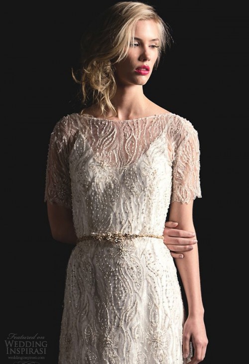 a plain slip underdress paired with a gorgeous sheer lace beaded overdress with a high neckline and short sleeves plus an embellished belt
