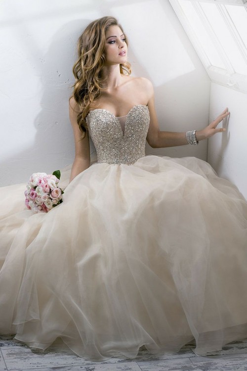 a neutral strapless wedding ballgown with a beaded bodice and a tulle skirt is a bold and timeless idea for a glam bride