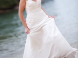 an A-line wedding dress with lace straps, a draped bodice and a V-neckline will fit a more formal wedding at the beach