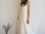 a lace A-line wedding dress with straps and a train and a floral crown to look super romantic