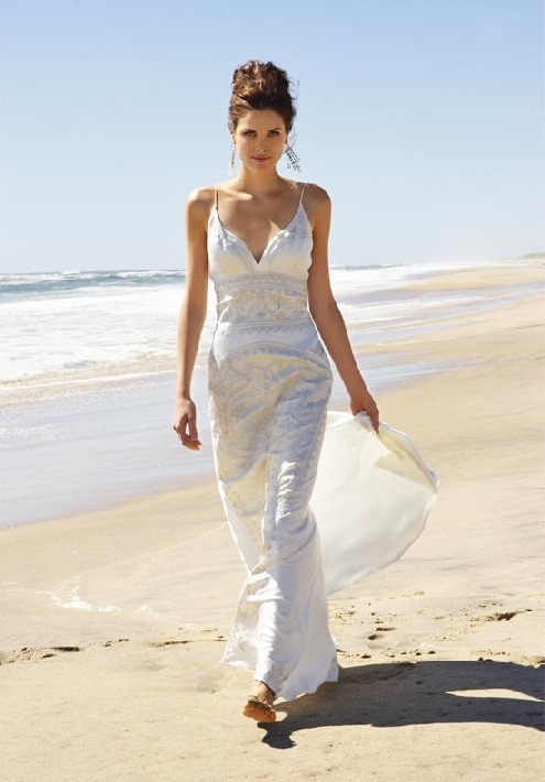 an embroidered fitting wedding dress with spaghetti straps, barefoot sandals and statement earrings
