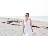 a modern white draped sheath wedding dress and bare feet for an elegant and stylish bridal look
