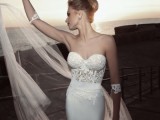 a gorgeous sheath wedding dress with a bustier lace bodice and a plain skirt plus a long and airy veil