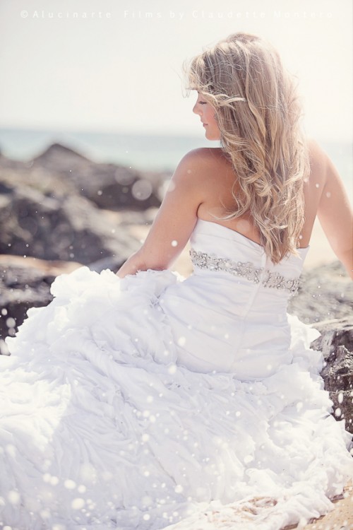 a classic strapless sheath wedding dress with a ruffle skirt and an embellished sash