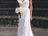 a simple and beautiful draped sheath wedding dress with ruffles and a depe neckline and sandals for a comfy and casual look