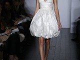a whimsy short wedding dress of a shiny fabric, with spaghetti straps and a draped skirt
