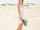 a simple modern plain short wedding dress with a deep neckline and spaghetti straps for a modern beach bride