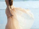 a unique strapless wedding dress with an embellished bodice and a flowy blush skirt for girls who prefer colors