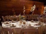 a neutral barn wedding tablescape with neutral linens, a dried bloom centerpieces and vintage porcelain and mugs
