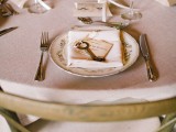 a neutral barn wedding table with simple linens, green hydrangeas, elegant cutlery and glasses