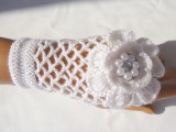 white crochet fingerless gloves with large crochet flowers are amazing for a winter bride who loves vintage and chic