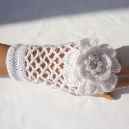 white crochet fingerless gloves with large crochet flowers are amazing for a winter bride who loves vintage and chic