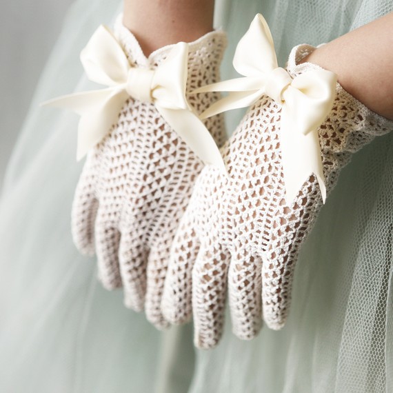 Classic crochet white gloves with large bows are great for any vintage bridal look and will keep you more comfortable in fall or winter