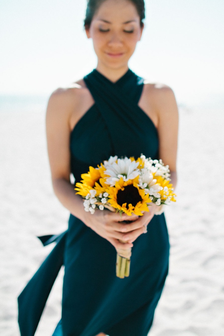 An elegant black bridesmaid dress with a criss cross neckline is a stunning idea for a refined beach wedding