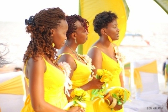 Bright yellow A line bridesmaid dresses with V necklines and straps and matching earrings to add bright colors to the wedding