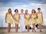 yellow strapless short dresses with draped bodices are a bright touch to a beach wedding