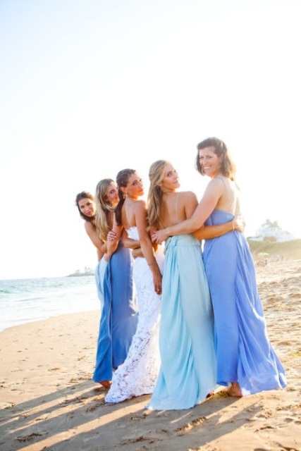 mismatching aqua and purple maxi bridesmaid dresses are beautiful and romantic for a beach wedding