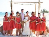 coral knee dresses with a strap on one shoulder are lovely and bright and can be worn to a bold beach wedding