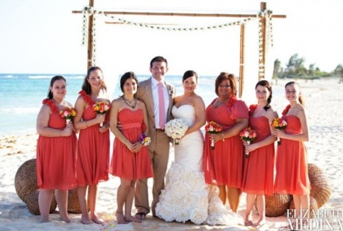 coral knee dresses with a strap on one shoulder are lovely and bright and can be worn to a bold beach wedding