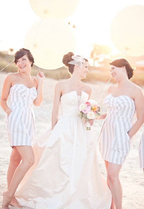 Striped strapless over the knee dresses with pockets with draped bodices are cool and relaxed gowns for a beach wedding