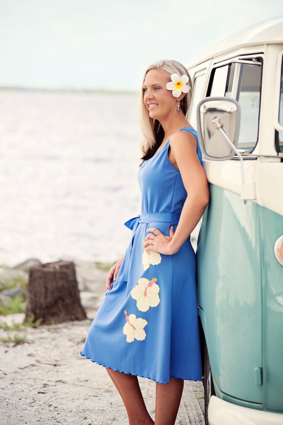 An electric blue midi bridesmaid dress with a florla pattern and thick straps is a bold and stylish idea