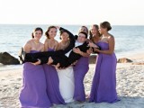 strapless purple bridesmaid dresses with draped bodices are bold and chic, perfect for a refined wedding