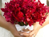 a hot red wedding bouquet with a neutral wrap and a bow is a lovely idea for a bright and colorful summer wedding