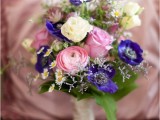 a bold wedding bouquet of pink, neutral and depe purple blooms and some greenery for a contrasting wedding with a bit of color