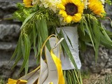 a bright wedding bouquet of sunflowers, billy balls and white hydrangeas, greenery and a neutral wrap is amazing for a rustic summer wedding