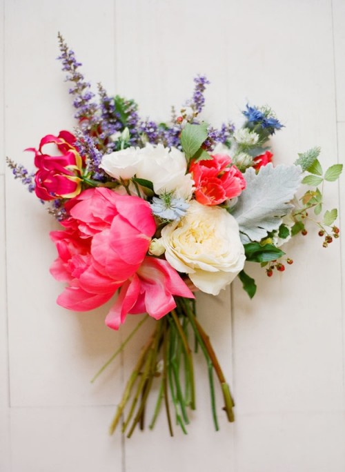 a bright wedding bouquet of pink, purple, blue and white blooms, pale leaves and a lot of texture and dimension for a relaxed summer wedding