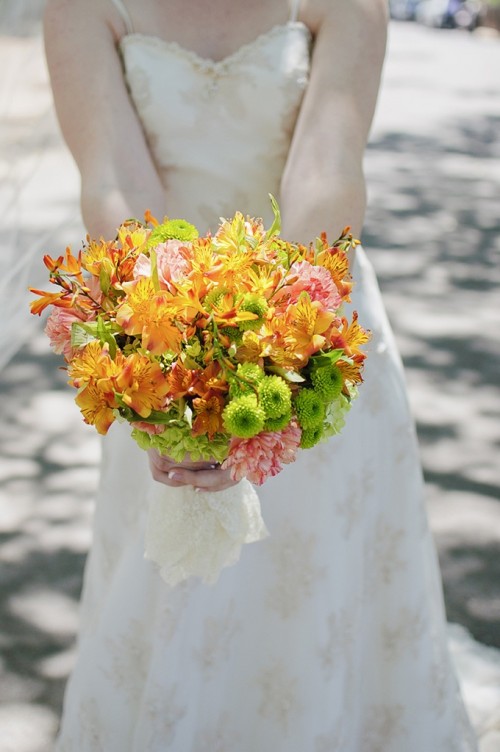 a bold summer wedding bouquet of yellow, pink and green blooms is a bright and chic solution for a summer wedding