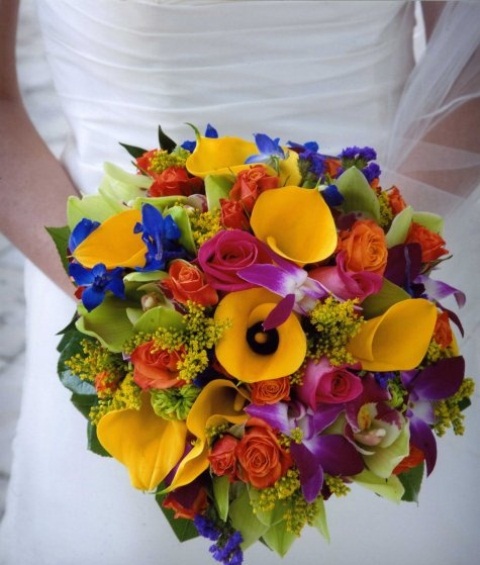 a super colorful wedidng bouquet with yellow, hot pink, deep blue and purple blooms and some greenery for an all-colorful wedding