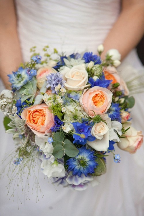 a lovely and bright summer wedding bouquet of white, peachy pink and blue blooms and greenery is a cool idea for summer